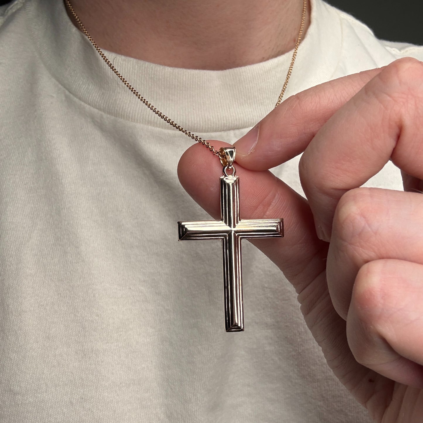 14K yellow gold XXL cross pendant with polished beveled edges handcrafted religious jewelry made in the USA on person