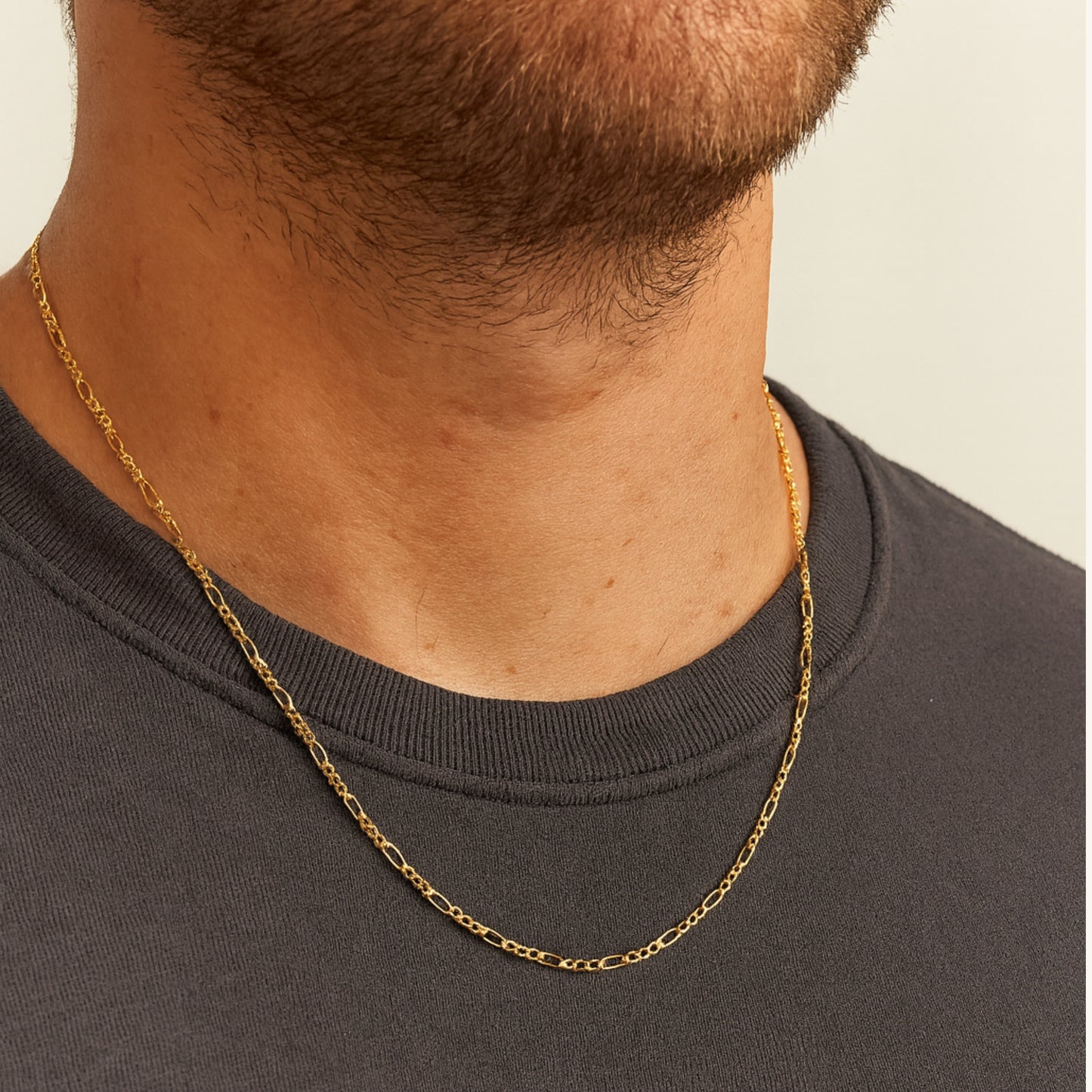Solid 14K Double Bonded Gold 20-22" adjustable Figaro chain lifestyle image on person
