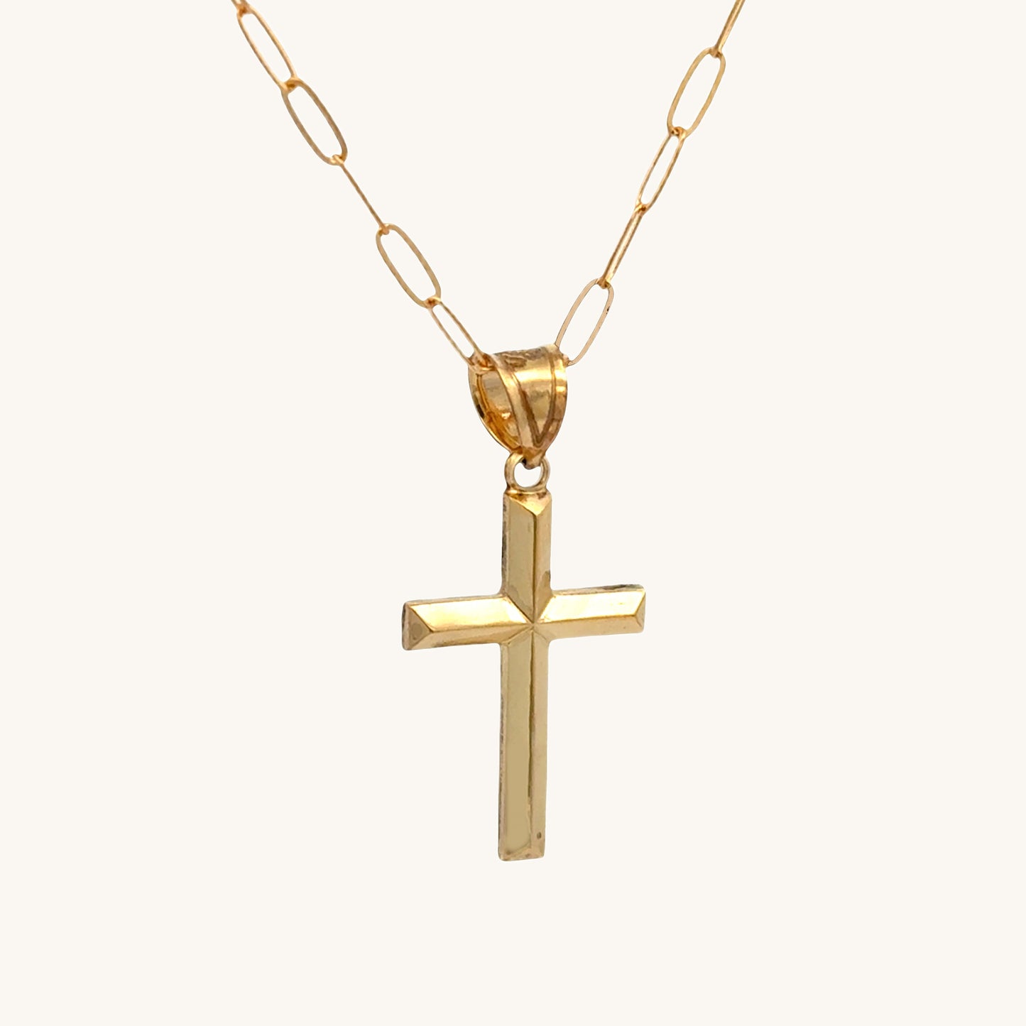 Small 14K double‑bonded gold simple cross pendant high‑polish finish on 16-18" paperclip chain angle image