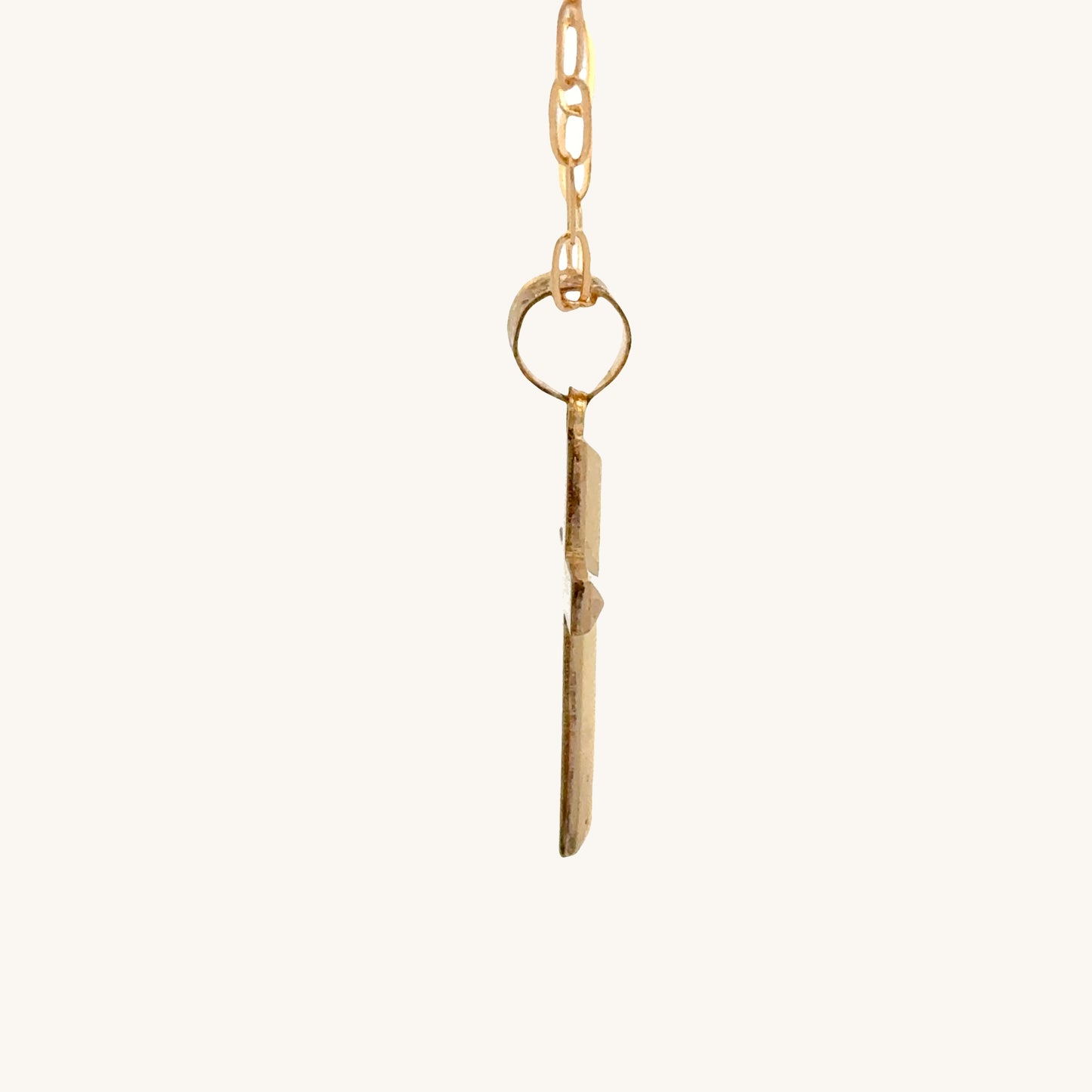 Small 14K double‑bonded gold simple cross pendant high‑polish finish on 16-18" paperclip chain side image