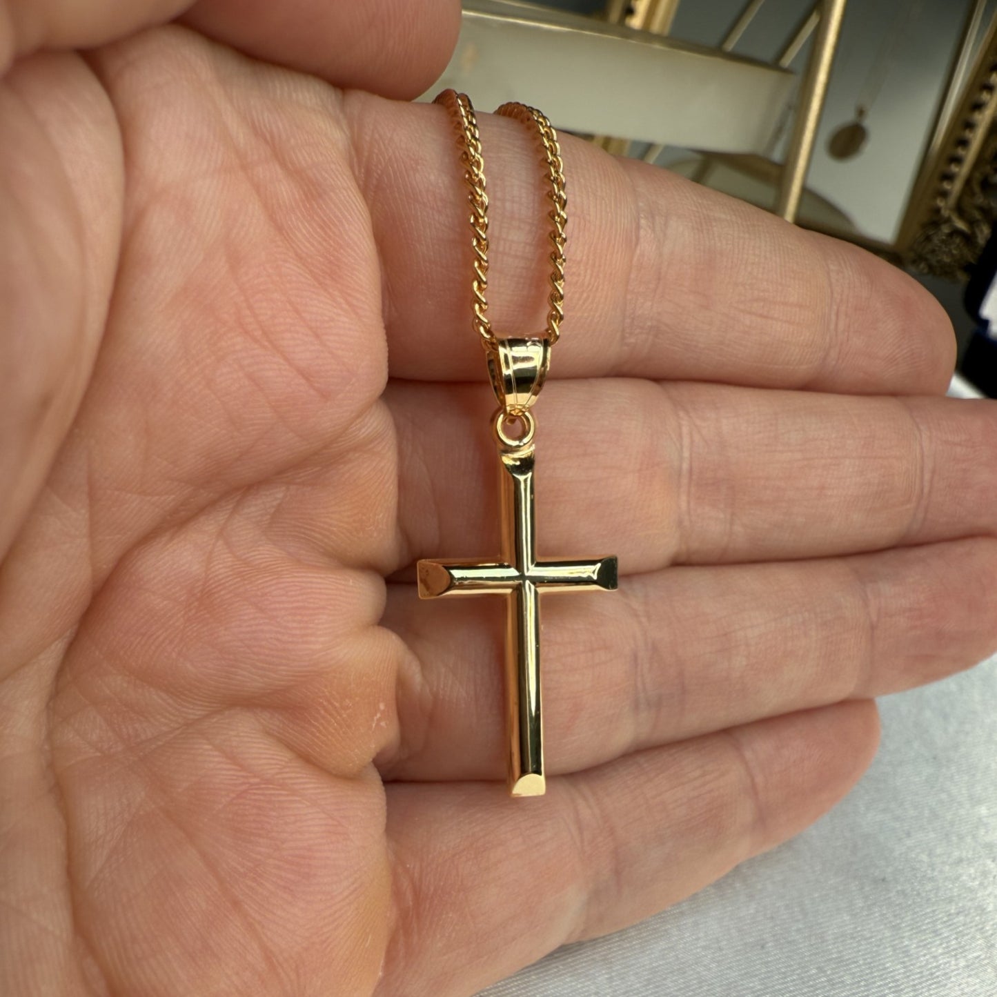 Solid 14K Double Bonded Gold timeless classic cross M pendant only lifestyle close up in hand