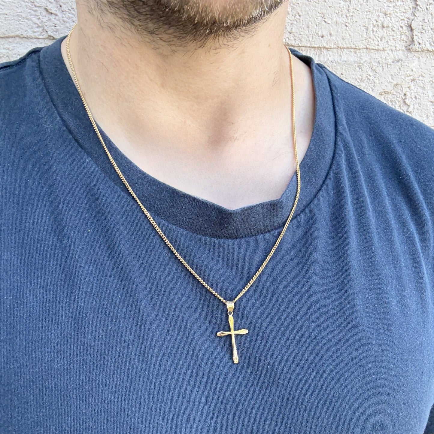 14K Double Bonded Gold M size Cross pendant only lifestyle image on man