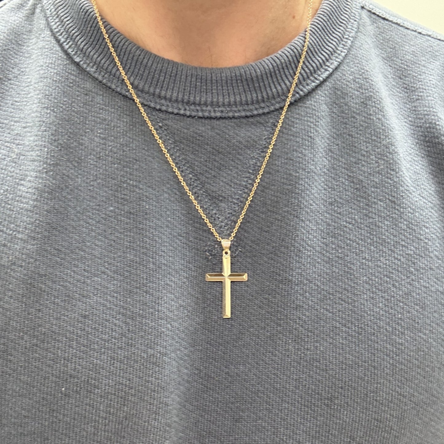 Large 14K double‑bonded gold simple cross pendant high‑polish finish on 16-18" paperclip chain lifestyle image S L