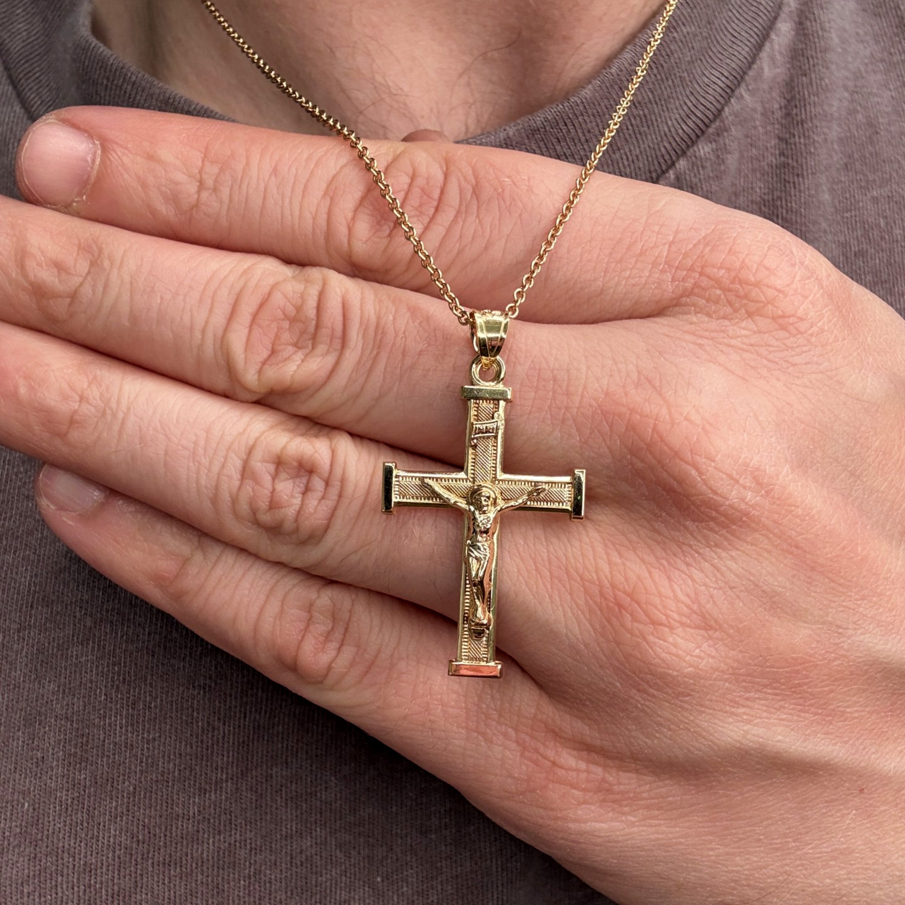 14K Double Bonded Gold INRI Crucifix L textured squared edge cross pendant only lifestyle on man image