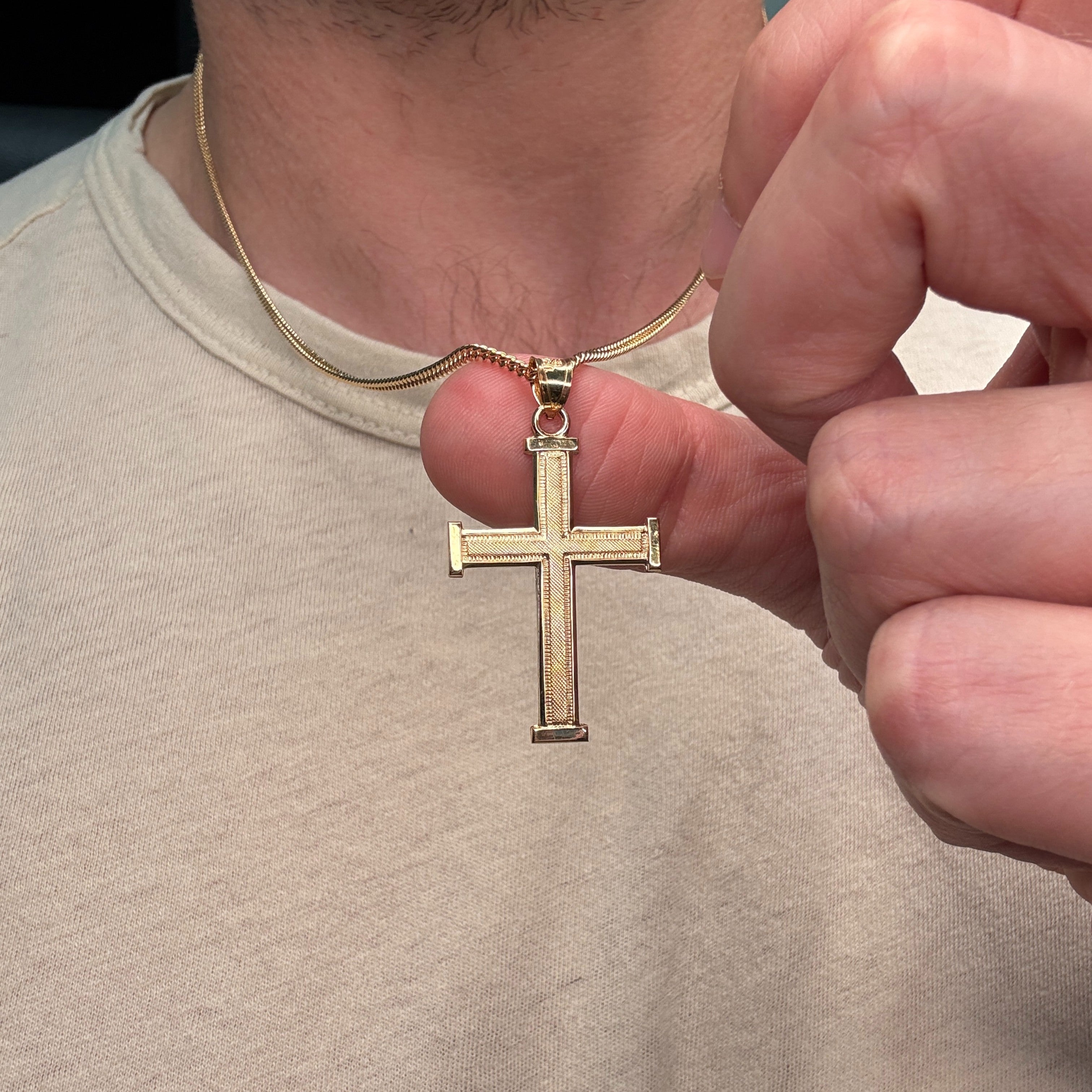 14K double‑bonded gold Cross pendant with texture design high‑polish finish on cable chain lifestyle close up