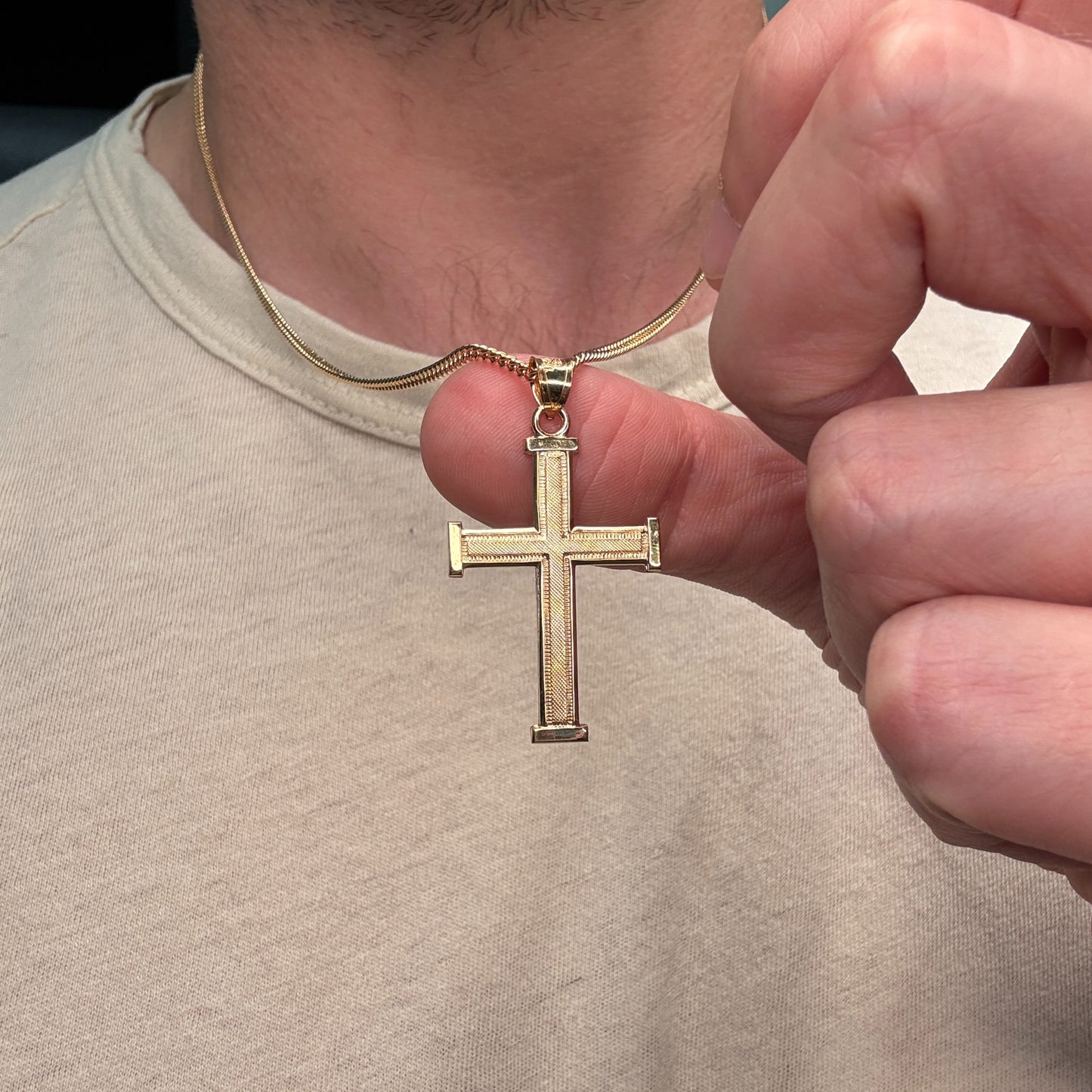 14K double‑bonded gold Cross pendant with texture design high‑polish finish on cable chain lifestyle close up