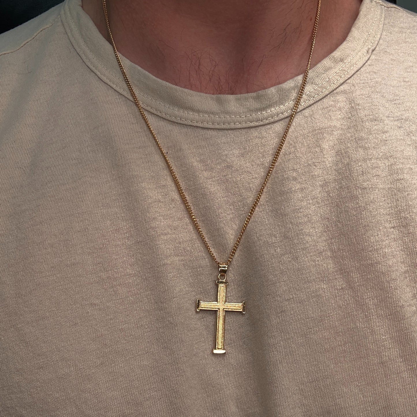 14K double‑bonded gold Cross pendant with texture design high‑polish finish on cable chain lifestyle on person