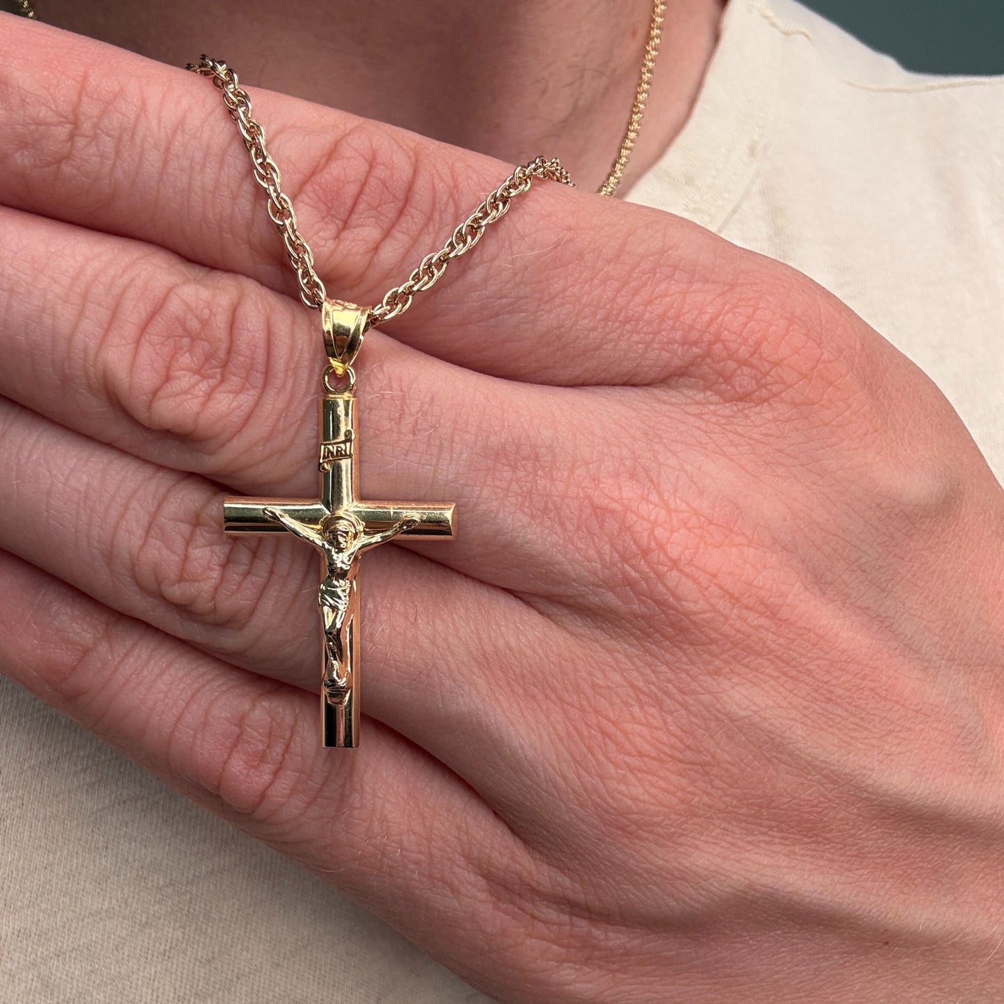 Solid 14K Double Bonded Gold INRI Crucifix pendant on rope chain main lifestyle close up image