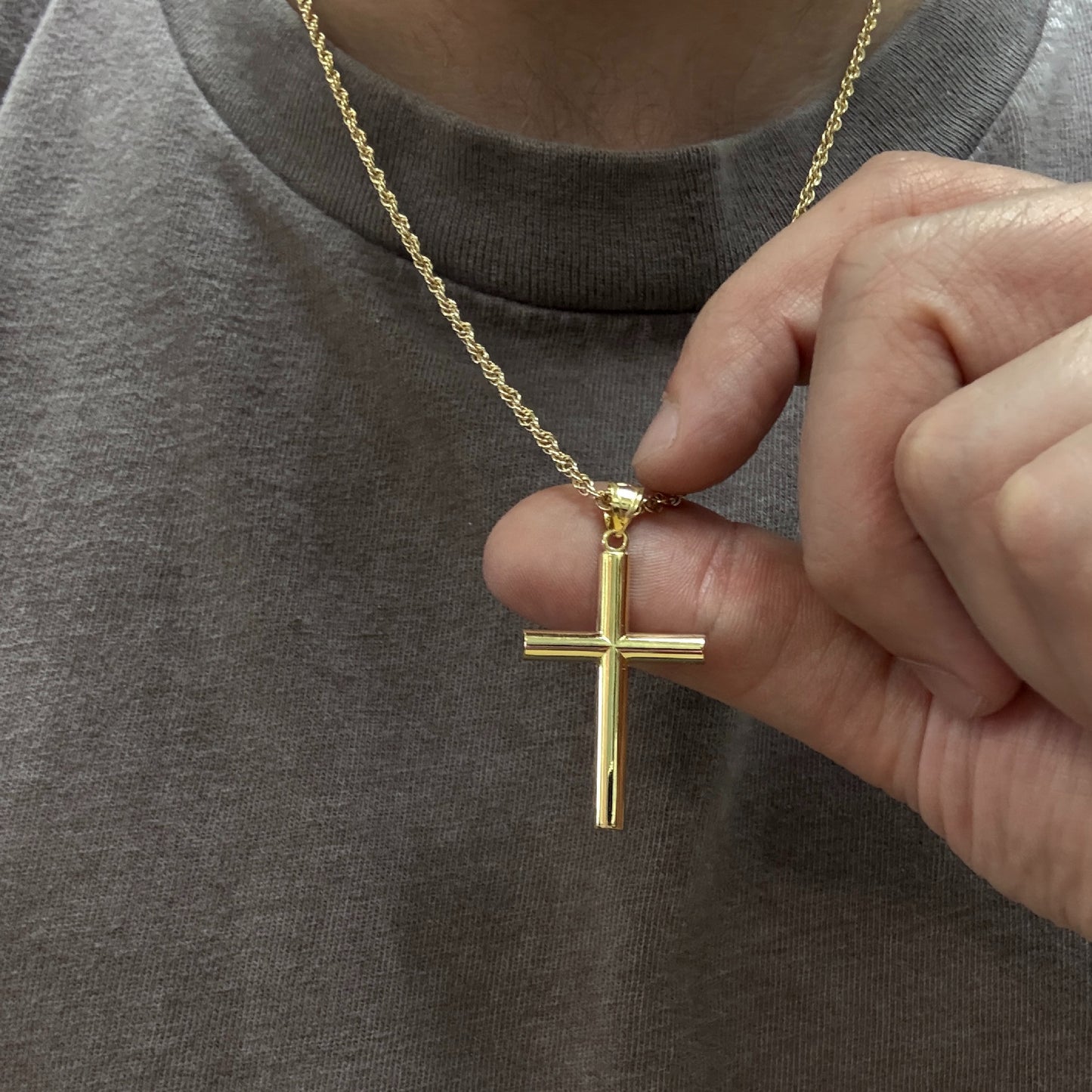 14K Double Bonded Gold Tube cross pendant on a gold filled cable chain lifestyle image close up