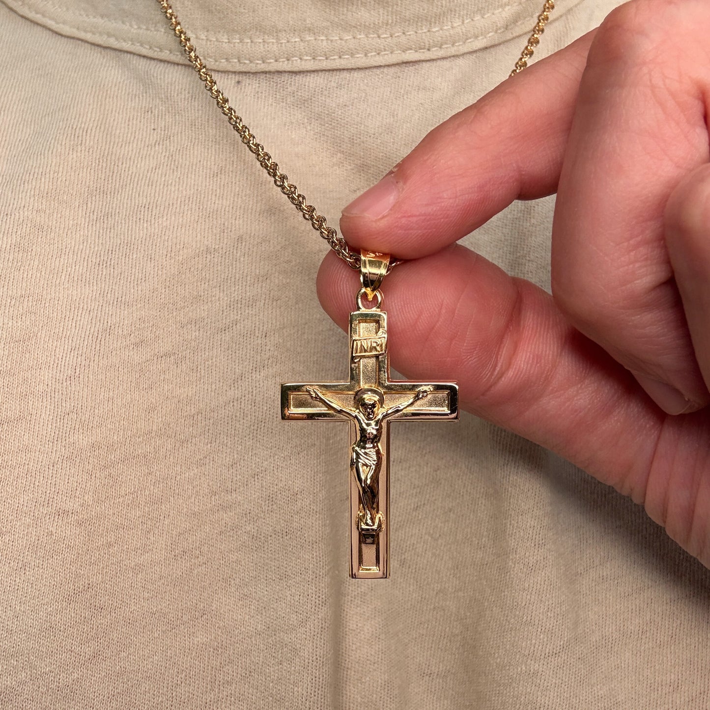 Solid 14K Double Bonded Gold XXL plain polished INRI Crucifix cross pendant on a rope chain lifestyle being held