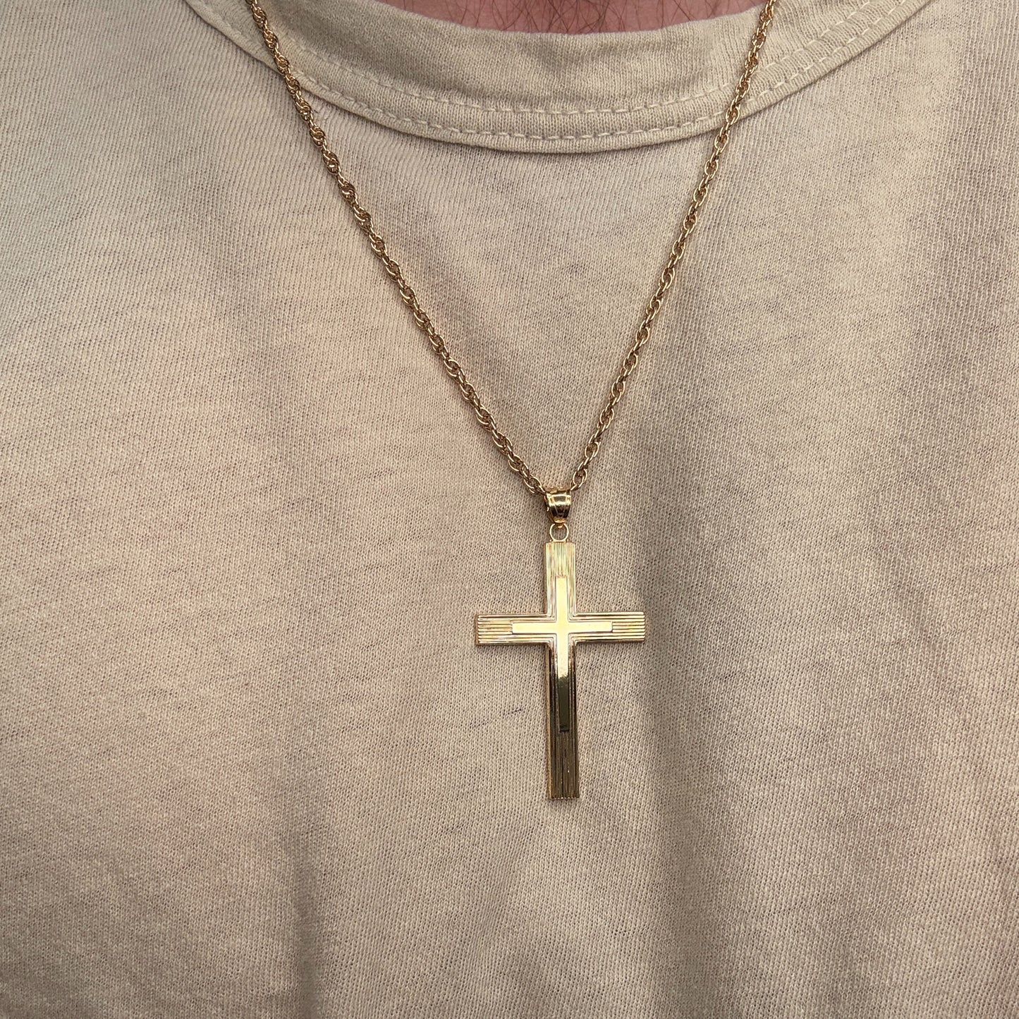 Solid 14K Double Bonded Gold XXL Engine-Turn design Cross pendant on a cable chain being worn image