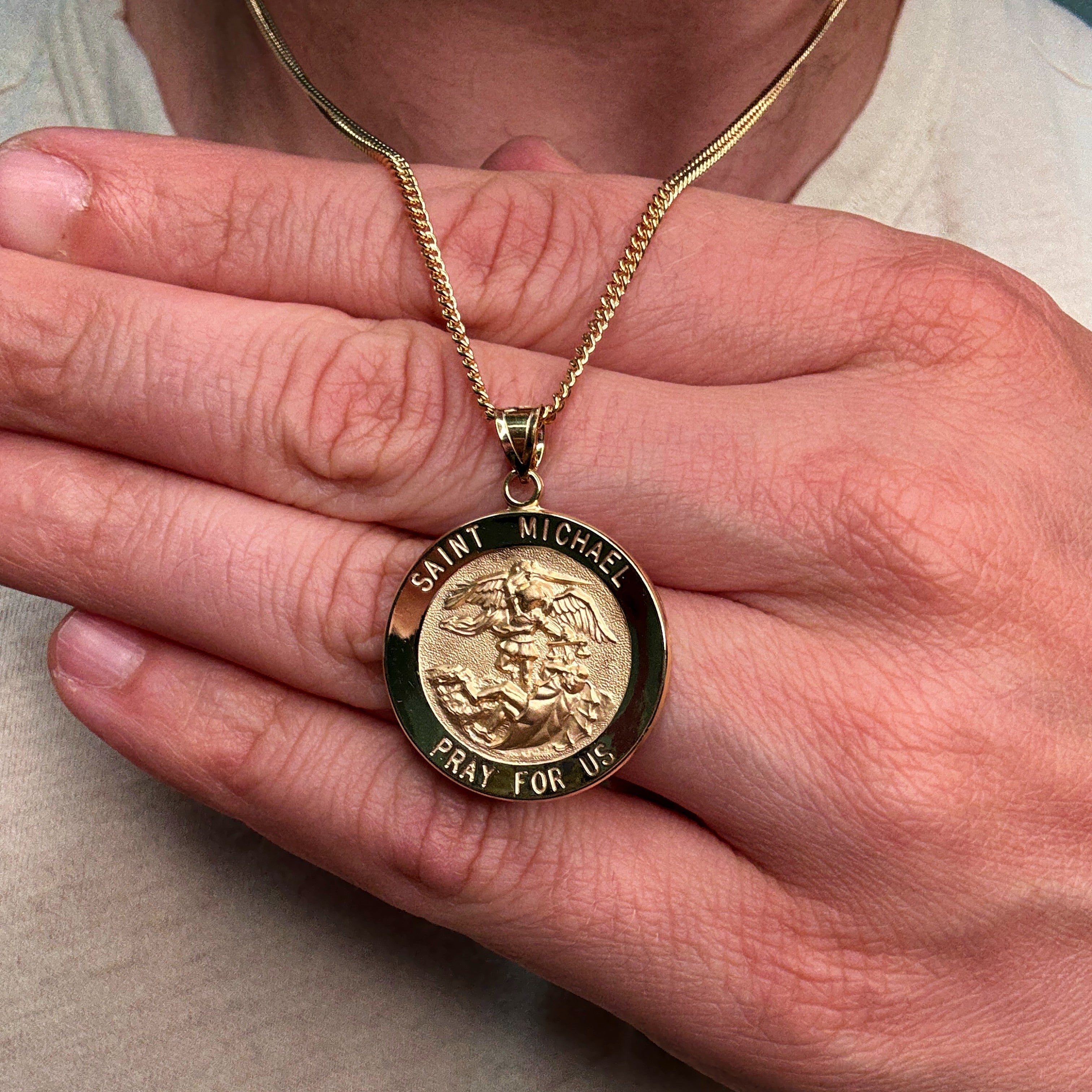 Solid 14K Double Bonded Gold Saint Michael pendant medal XL (size off Quarter) M (size of Dime) on cable chain lifestyle close up image