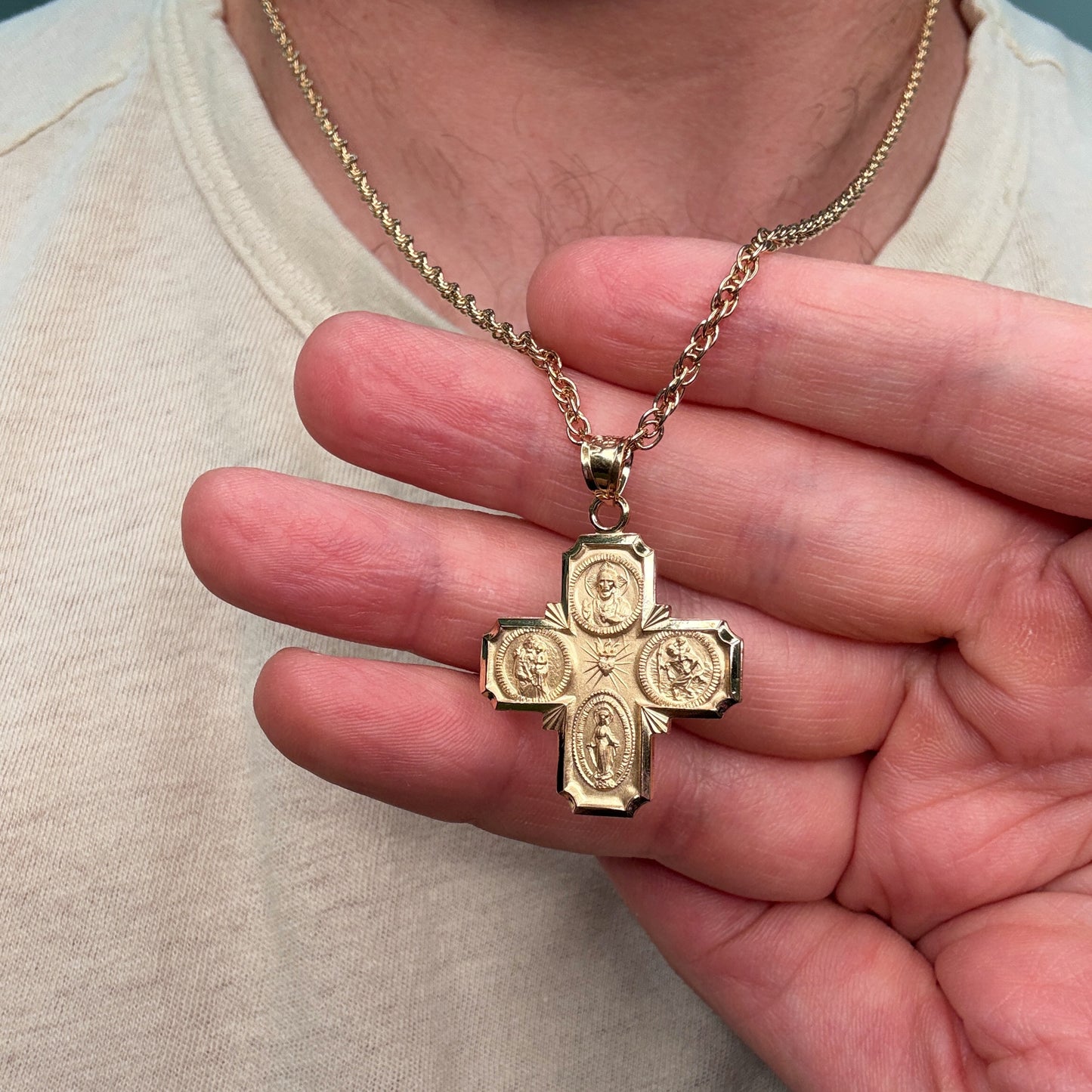 Solid 14K Double Bonded Gold Four Way Cross medal on rope chain lifestyle image close up