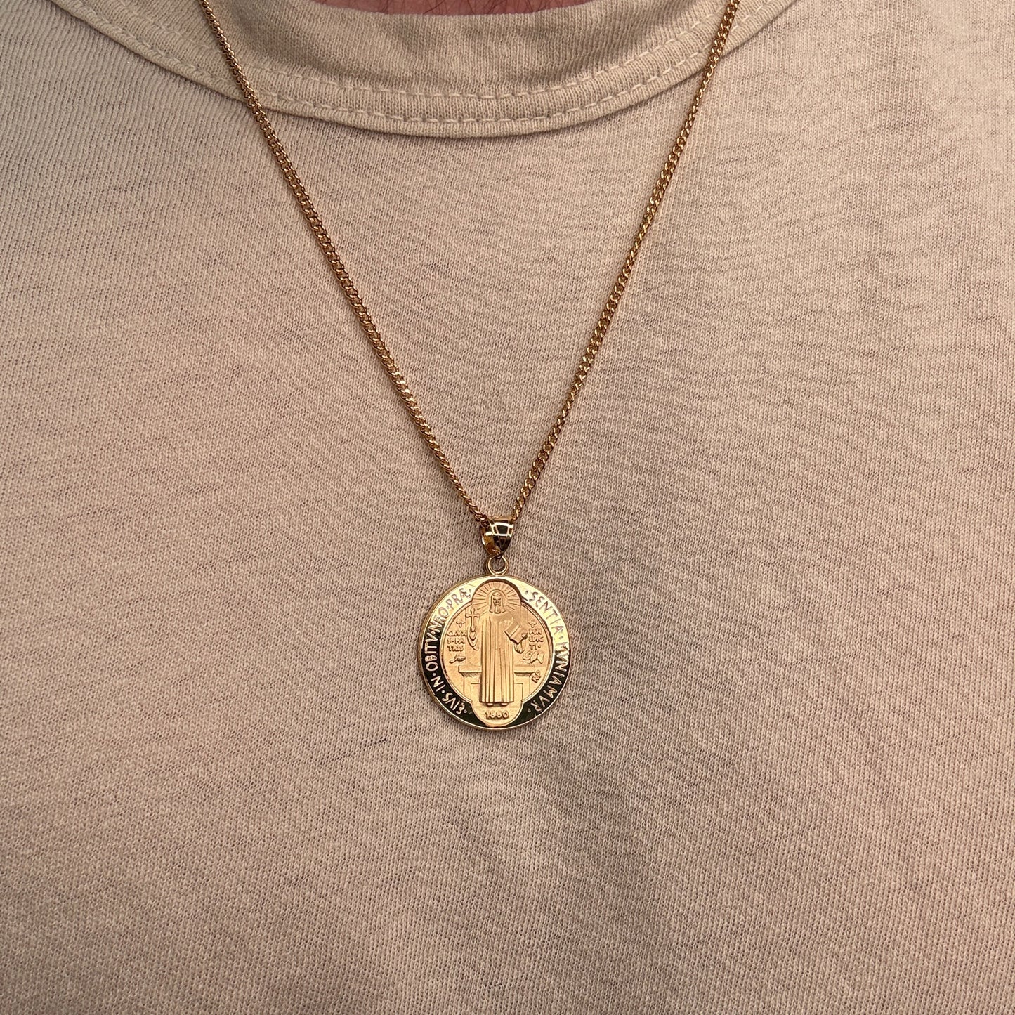 Solid 14K Double Bonded Gold Saint Benedict pendant medal on cable chain lifestyle image being worn L (size of Nickel) M (size of Dime)