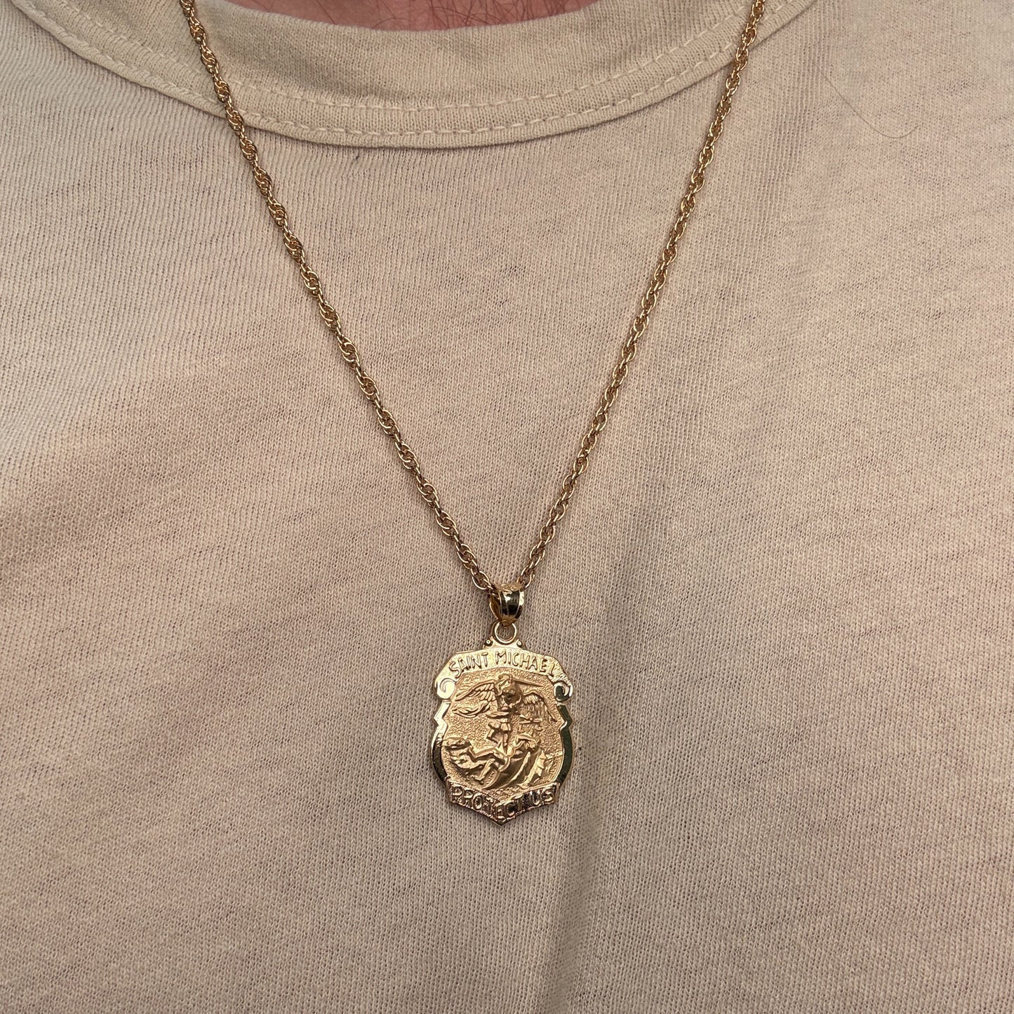 Solid 14K Double Bonded Gold Saint Michael Badge Shield medal on cable chain lifestyle being worn