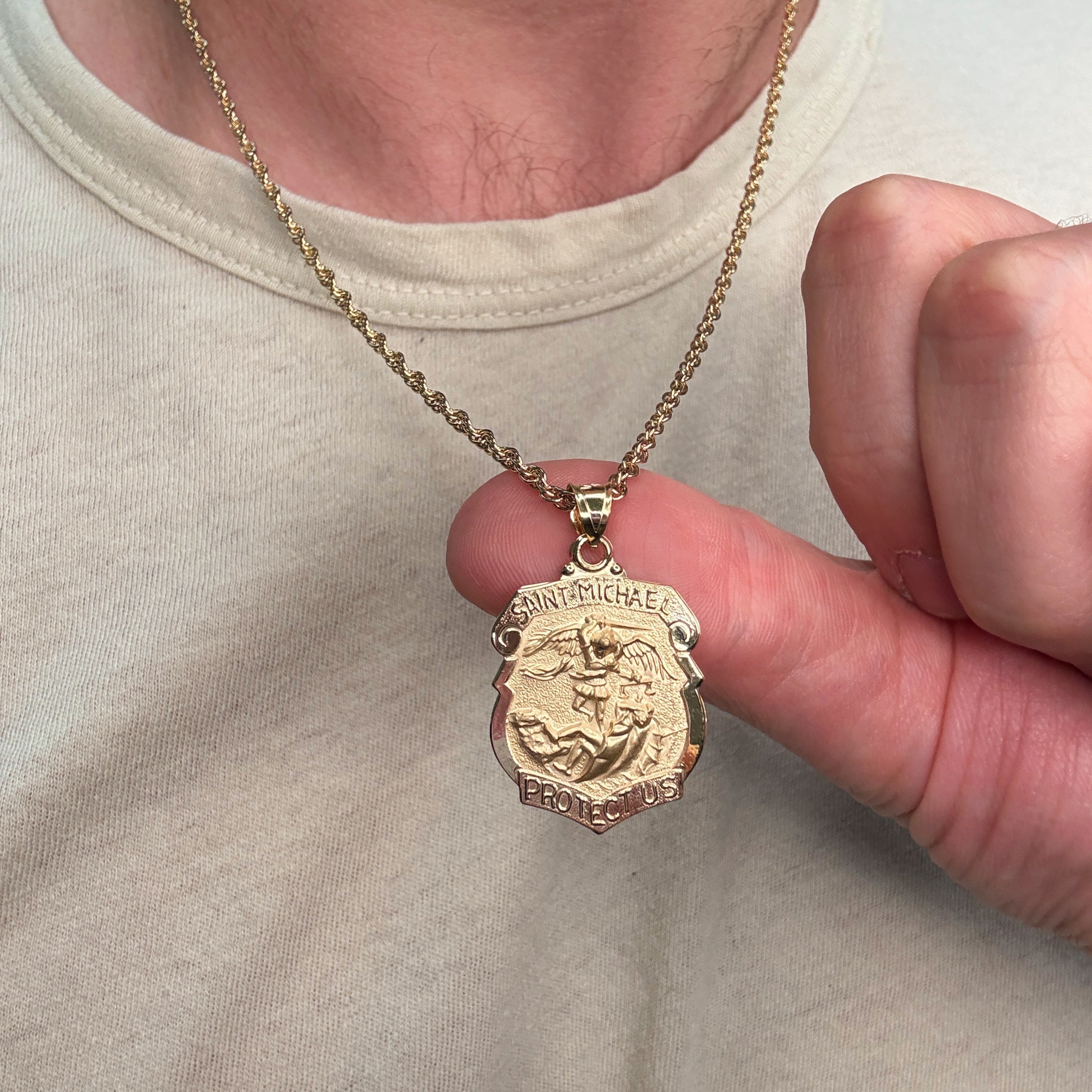 Solid 14K Double Bonded Gold Saint Michael Badge Shield medal on cable chain lifestyle close up image