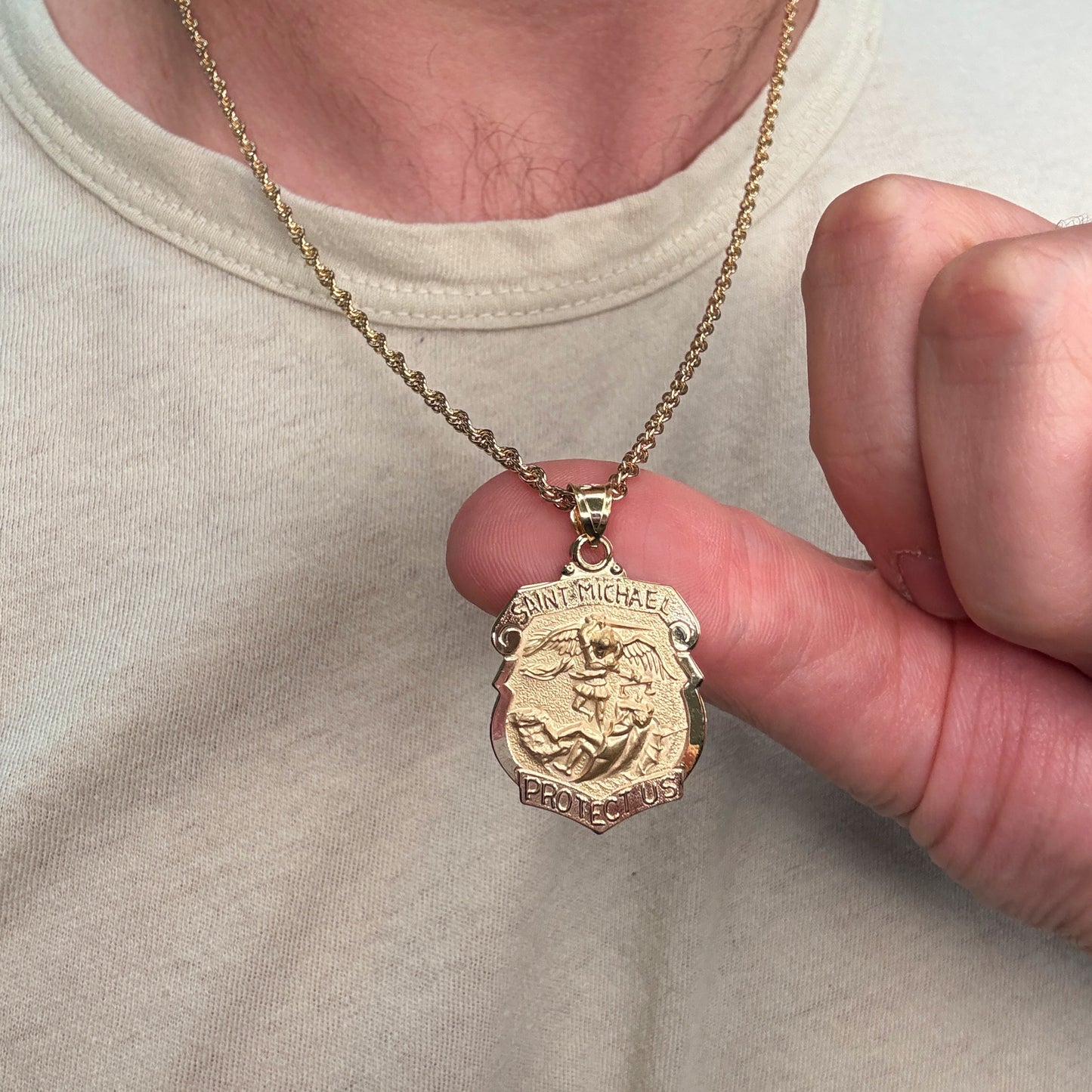 Solid 14K Double Bonded Gold Saint Michael Badge Shield medal on cable chain lifestyle close up image