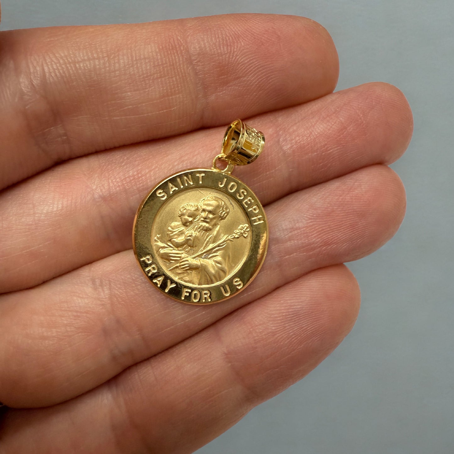 Solid 14K Double Bonded Gold Saint Joseph pendant medal lifestyle close up image size L (size of Nickel) M (size of Dime)