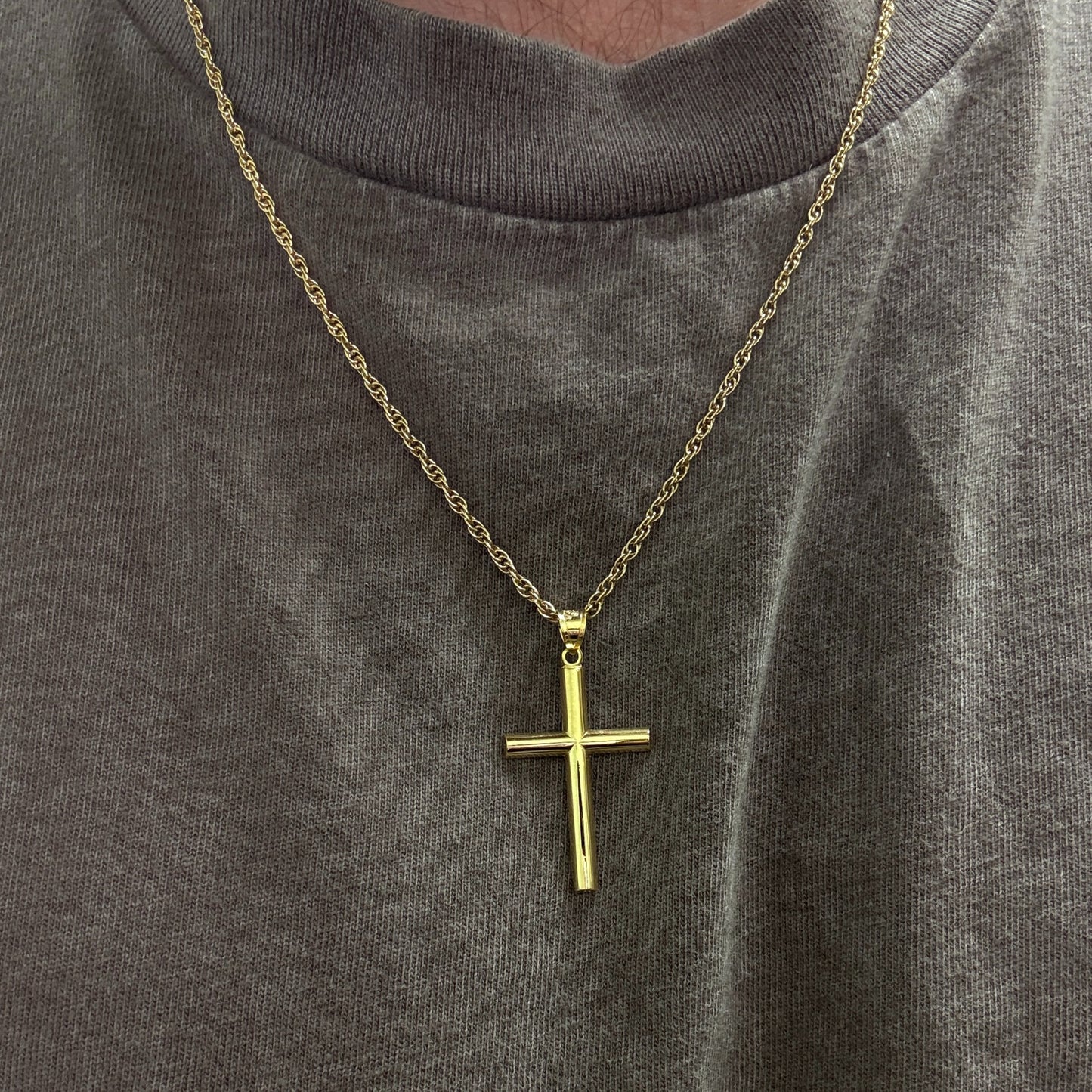 14K Double Bonded Gold Tube cross pendant on a gold filled cable chain lifestyle image being worn